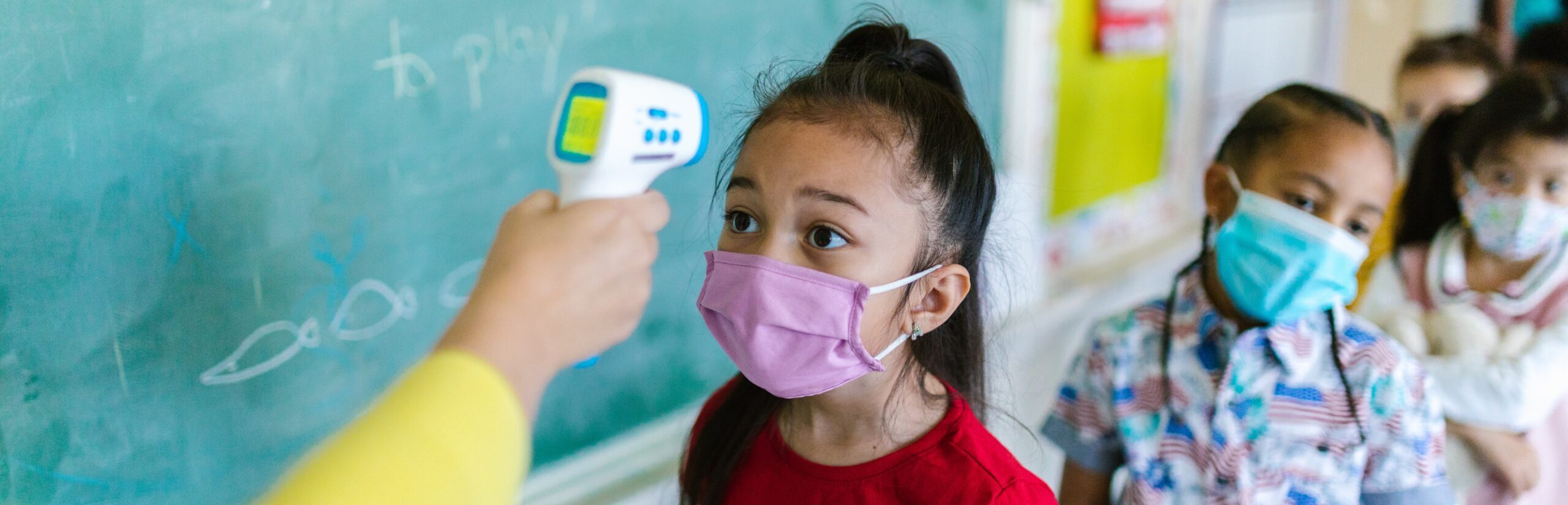 Image of girl getting her temperature taken